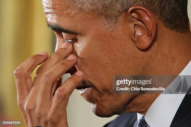 President Barack Obama wipes away tears as talks about the victims of the 2012 Sandy Hook Elementary School shooting and about his efforts to...