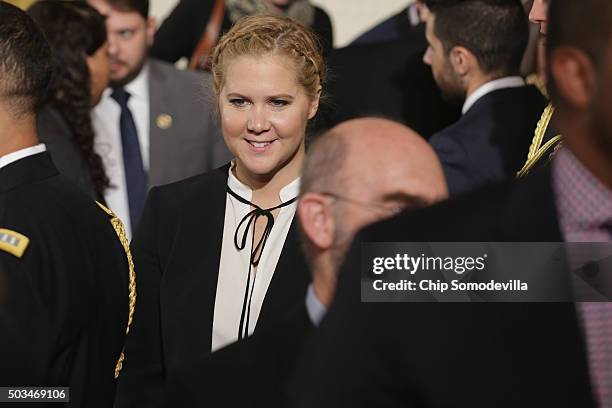 Comedian Amy Schumer poses for photographs with victims of gun violence, their family and supporters after U.S. President Barack Obama delivered...