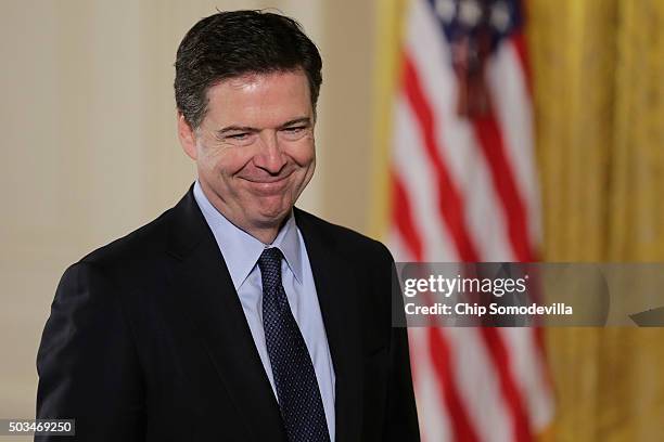 Federal Bureau of Investigation Director James Comey arrives in the East Room before President Barack Obama delivers remarks about his efforts to...