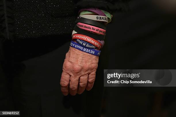 Gun control advocate wears a series of plastic advocacy bracelets while waiting for U.S. President Barack Obama to deliver remarks about his efforts...