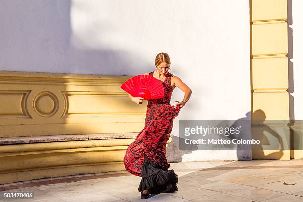 flamenco dancer performing outdoors in seville, andalusia, spain - baile flamenco fotografías e imágenes de stock
