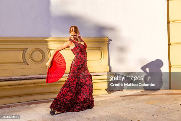 flamenco dancer performing outdoors in seville, andalusia, spain - baile flamenco fotografías e imágenes de stock