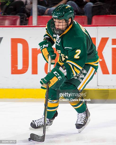 Casey Purpur of the Northern Michigan Wildcats skates up ice with the puck against the Michigan State Spartans during the consolation game of the...