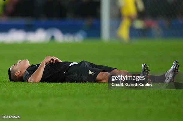 Philippe Coutinho of Liverpool reacts after going down with an injury during the Capital One Cup semi final, first leg match between Stoke City and...