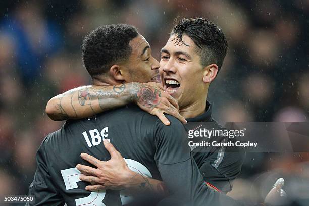Jordon Ibe of Liverpool is congratulated by teammate Roberto Firmino of Liverpool after scoring the opening goal during the Capital One Cup semi...