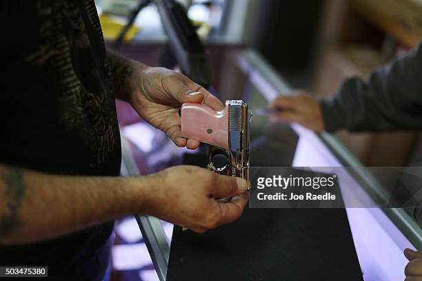 Customer shops for a handgun at the K&W Gunworks store on the day that U.S. President Barack Obama in Washington, DC announced his executive action...