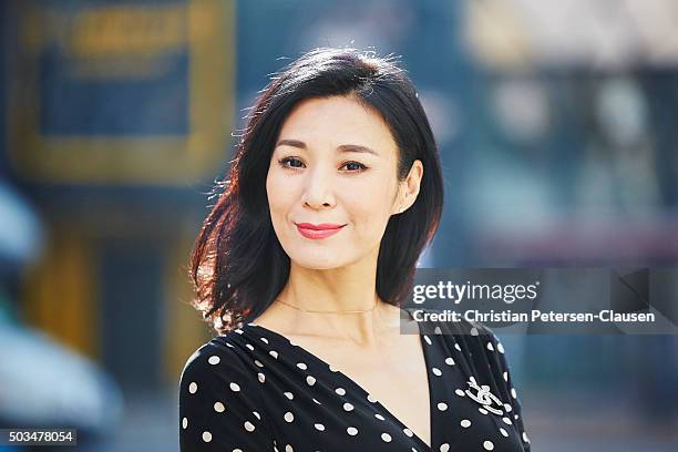 portrait of mature chinese businesswoman smiling outside - china middle class stock pictures, royalty-free photos & images