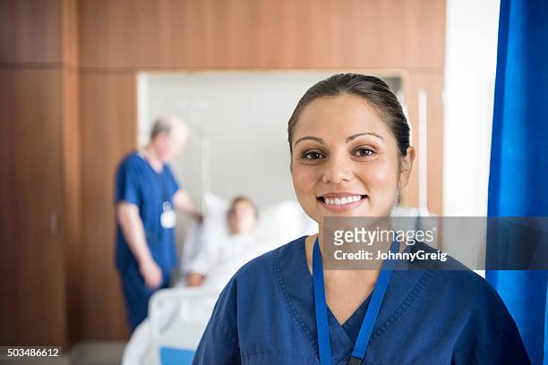 ethnic nurse on hospital ward smiling to camera, portrait - australian aboriginal stock pictures, royalty-free photos & images