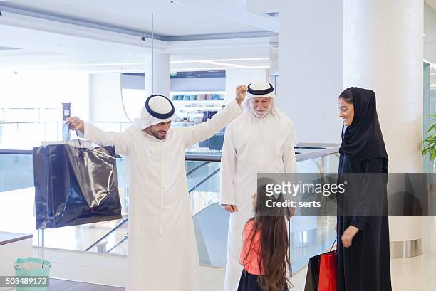 arabian family in shopping mall - emirati family shopping stock pictures, royalty-free photos & images