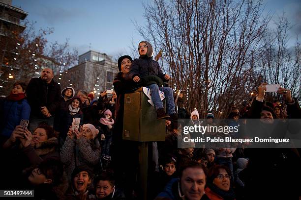 Children watch the 'Cabalgata de Reyes,' or the Three Kings parade on January 5, 2016 in Madrid, Spain. The traditional parade takes place during the...