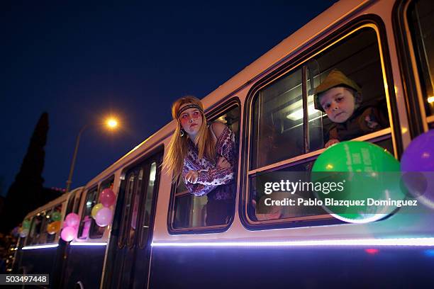 Performers looks out from an old bus during the 'Cabalgata de Reyes,' or the Three Kings parade on January 5, 2016 in Madrid, Spain. The traditional...
