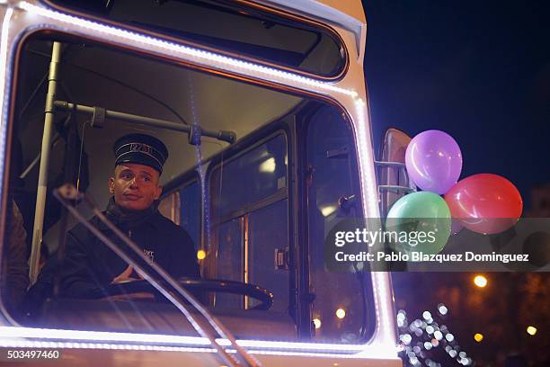 Performer drives an old bus during the 'Cabalgata de Reyes,' or the Three Kings parade on January 5, 2016 in Madrid, Spain. The traditional parade...