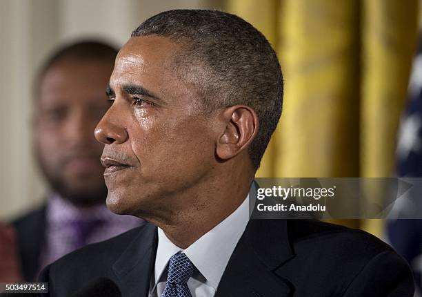 President Barack Obama gets tearful as he delivers remarks in the East Room of the White House about his efforts to increase federal gun control on...