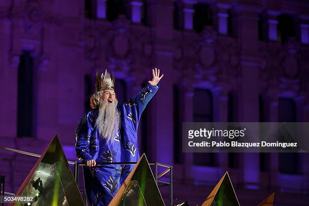 Performer dressed as Melchoir King waves his hand to the public as he rides a float during the 'Cabalgata de Reyes,' or the Three Kings parade on...