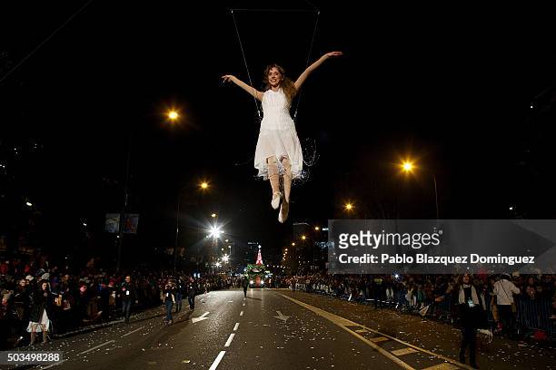 Performer dance as she hangs from a balloon during the 'Cabalgata de Reyes,' or the Three Kings parade on January 5, 2016 in Madrid, Spain. The...