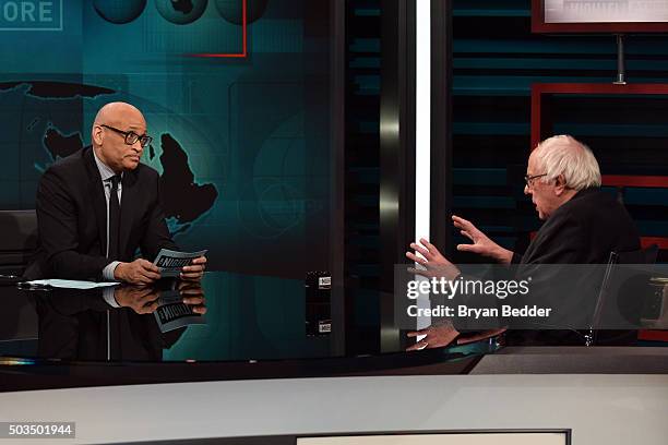 Host Larry Wilmore speaks with Senator Bernie Sanders on Comedy Central's "The Nightly Show With Larry Wilmore" on January 5, 2016 in New York City.