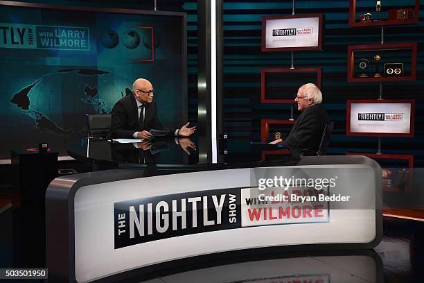 Host Larry Wilmore speaks with Senator Bernie Sanders on Comedy Central's "The Nightly Show With Larry Wilmore" on January 5, 2016 in New York City.