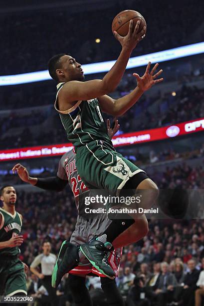 Jabari Parker of the Milwaukee Bucks goes up for a shot past Taj Gibson of the Chicago Bulls at the United Center on January 5, 2016 in Chicago,...