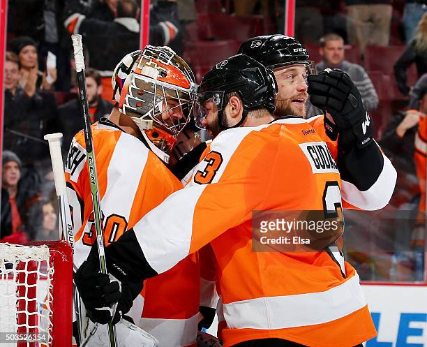 Michal Neuvirth of the Philadelphia Flyers is congratulated by teammates Radko Gudas and Nick Schultz after the game against the Montreal Canadiens...