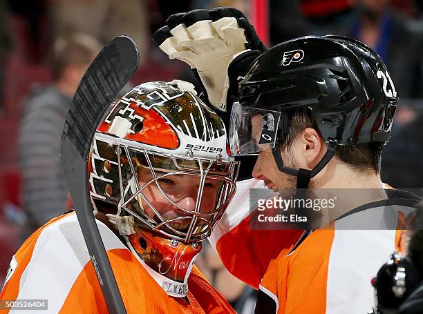 Michal Neuvirth of the Philadelphia Flyers is congratulated by teammate Scott Laughton after the win over the Montreal Canadiens at the Wells Fargo...