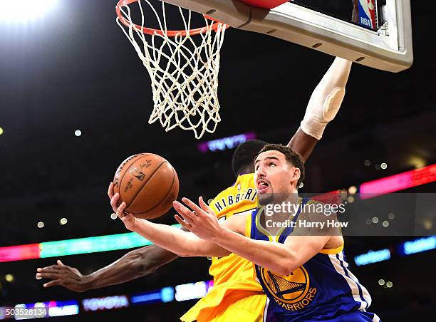 Klay Thompson of the Golden State Warriors attempts a layup around Roy Hibbert of the Los Angeles Lakers during the first half at Staples Center on...