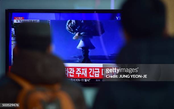 People watch a news report on North Korea's first hydrogen bomb test at a railroad station in Seoul on January 6, 2016. South Korea "strongly"...