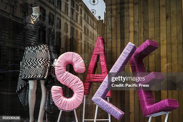 Shop window offering discounts during the winter sales in downtown Rome, Italy. The first day of winter sales in many Italian cities begins and...