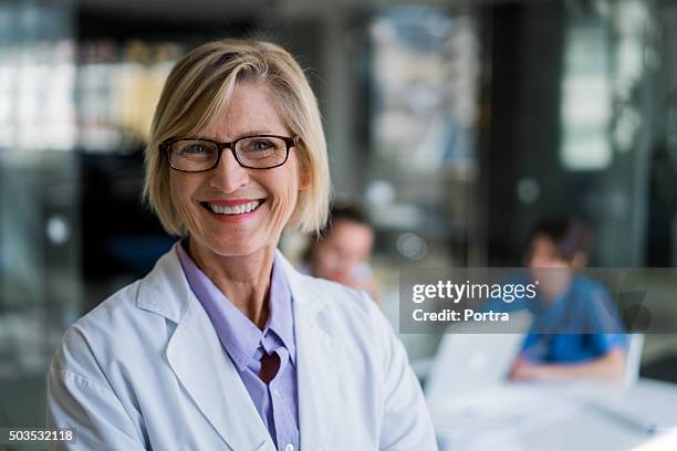 happy female doctor in hospital - healthcare leadership stock pictures, royalty-free photos & images