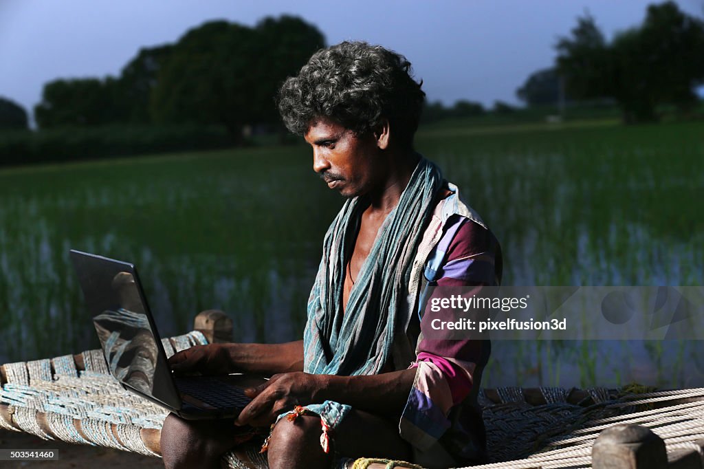 Young Farmer Using Laptop