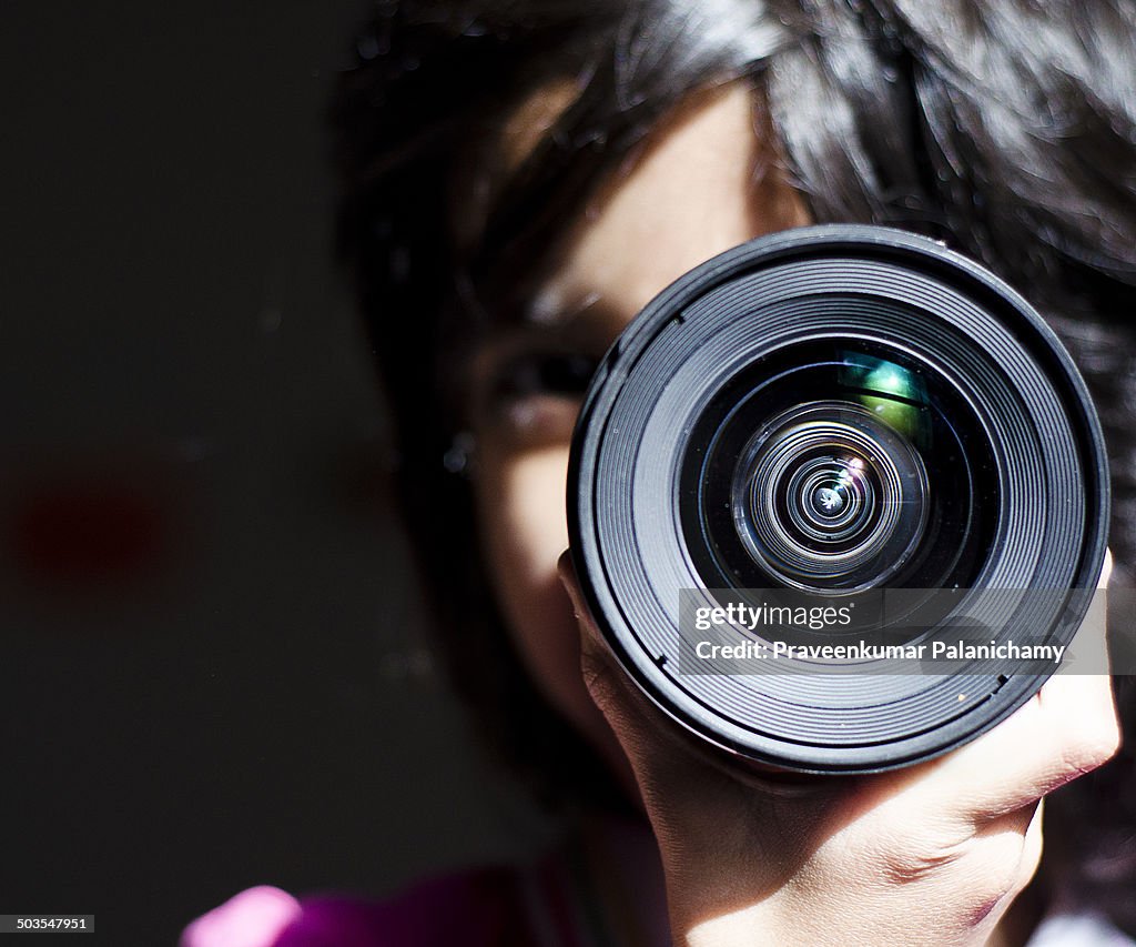 Portrait of a child with a lens