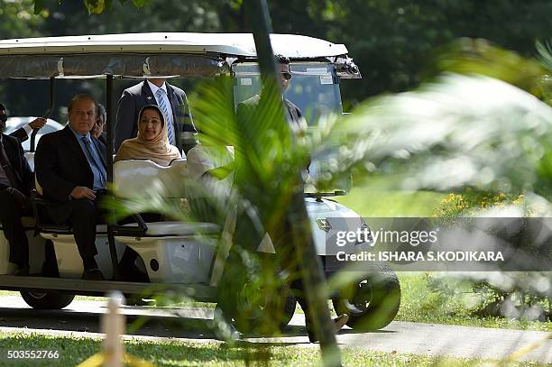 Pakistani Prime Minister Nawaz Sharif and his wife Kalsoom Nawaz Sharif ride in a buggy during a visit to The Peradeniya Royal Botanical Garden in...