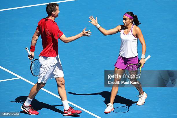 Kenny De Schepper and Caroline Garcia of France celebrate a point in the mixed doubles match against Sabine Lisicki and Alexander Zverev of Germany...