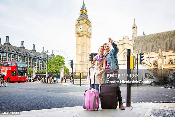 young tourist couple shoots selfie big ben london uk - london bus big ben stock pictures, royalty-free photos & images