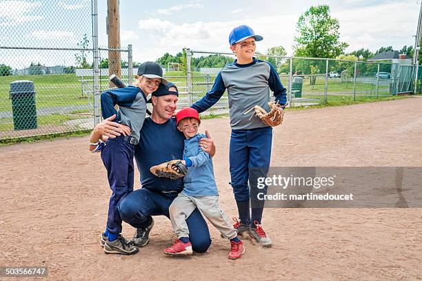 dad congratulating his sons after baseball game. - baseball huddle stock pictures, royalty-free photos & images