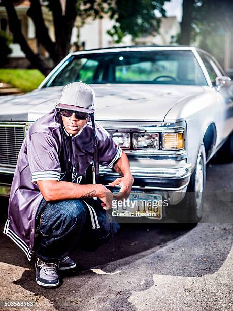 guy posing with his car - rap stockfoto's en -beelden