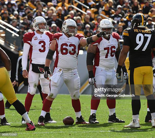 Center Lyle Sendlein of the Arizona Cardinals signals at the line of scrimmage as offensive lineman Mike Iupati and quarterback Carson Palmer look on...