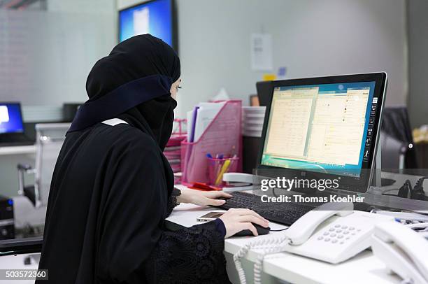 Riad, Saudi Arabia A young Arab woman sitting in front of a computer in the employment agency for women 'Glowork' on October 19, 2015 in Riad, Saudi...