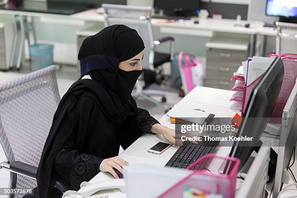 Riad, Saudi Arabia A young Arab woman sitting in front of a computer in the employment agency for women 'Glowork' on October 19, 2015 in Riad, Saudi...