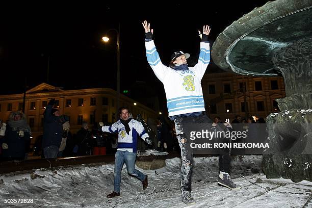 Finnish hockey fans celebrate the ice hockey junior world championship on the Market Square in the center of Helsinki, on early Wednesday morning,...