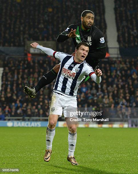 Craig Gardner of West Bromwich Albion is tackled by Glen Johnson of Stoke City during the Barclays Premier League match between West Bromwich Albion...