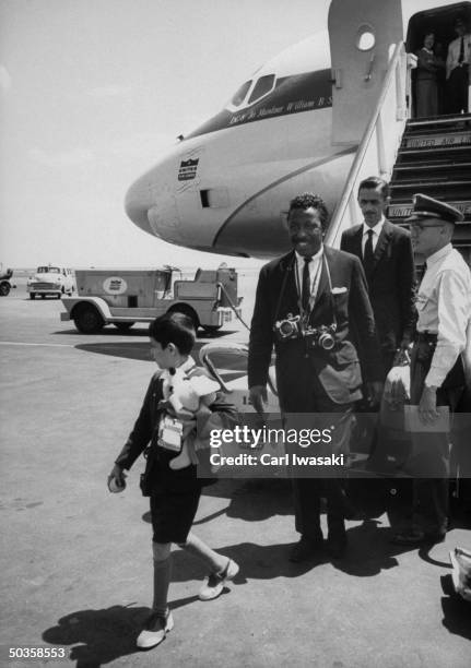 Photographer Gordon Parks arriving in US with Flavio da Silva , boy from slums of Rio de Janiero.