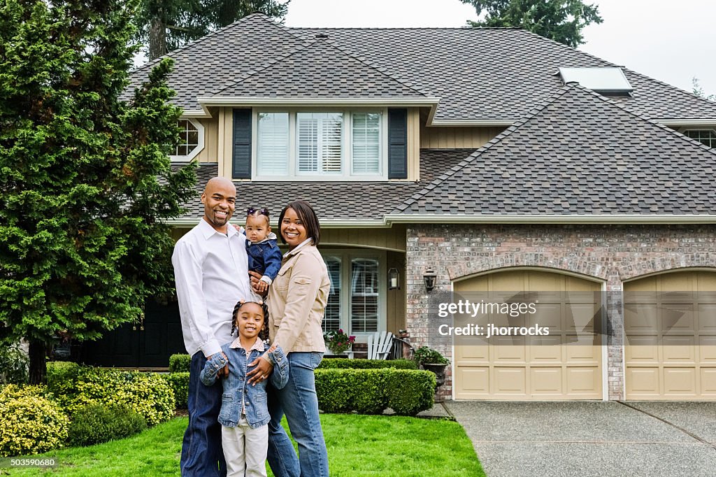 Family of Four at Home in Front Yard