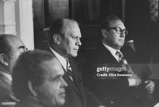 President Gerald R. Ford sitting with Secretary of State Henry A. Kissinger during a cabinet meeting.