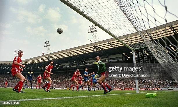 Wimbledon player Lawrie Sanchez flicks a header past Liverpool goalkeeper Bruce Grobelaar despite the attentions of cemtral defender Gary Ablett to...