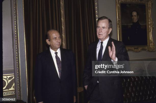 Vice President/President Elect George H. W. Bush , gesturing, standing with Venezuelan President elect Carlos Andres Perez .