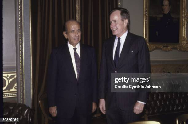 Vice President/President Elect George H. W. Bush , smiling with Venezuelan President elect Carlos Andres Perez .