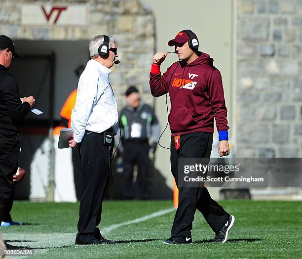 Head Coach Frank Beamer and Assistant Coach Shane Beamer of the Virginia Tech Hokies have a sideline discussion during the game against the North...