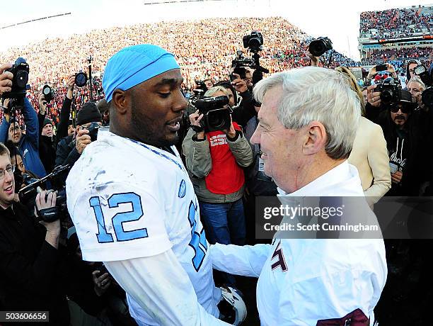 Head Coach Frank Beamer of the Virginia Tech Hokies is consoled after the game by Marquise Williams of the North Carolina Tar Heels on November 21,...