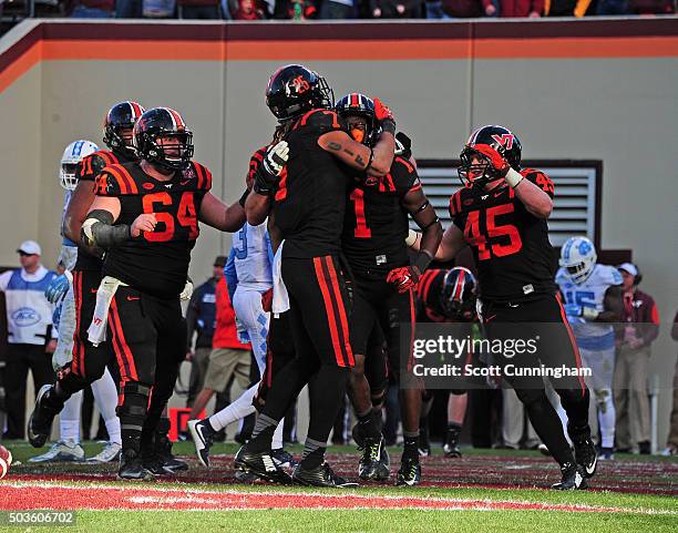 Isaiah Ford of the Virginia Tech Hokies is congratulated by Bucky Hodges after making a catch for a touchdown against the North Carolina Tar Heels on...