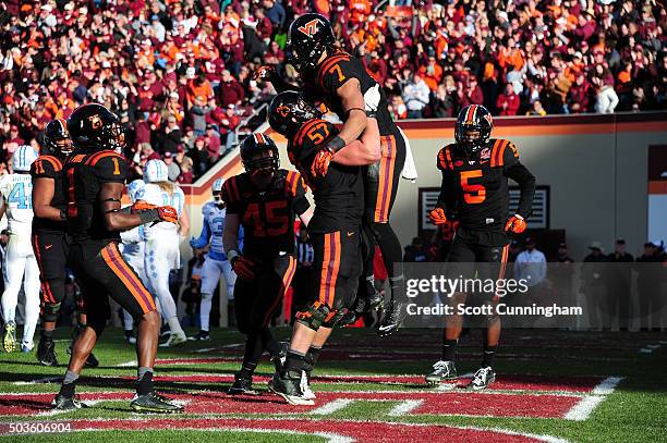 Bucky Hodges of the Virginia Tech Hokies is congratulated by Wyatt Teller after making a catch for a touchdown against the North Carolina Tar Heels...